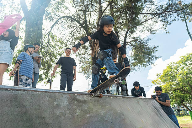 young people and children practicing skating in a skate park