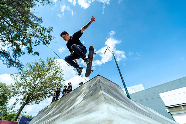young people and children practicing skating in a skate park