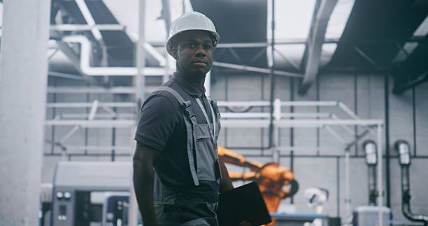 istock Professional Plant Manager Moving Through Industrial Workshop With Tablet in Hand 2254790196