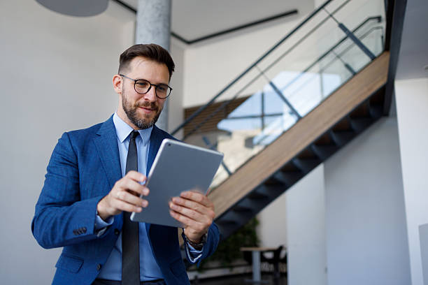 istock Business professional using digital tablet in modern office environment, connecting with technology for career success 2254792460