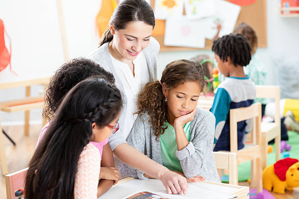 istock Teacher guides young students in a diverse classroom setting, fostering learning and togetherness. 2254792979