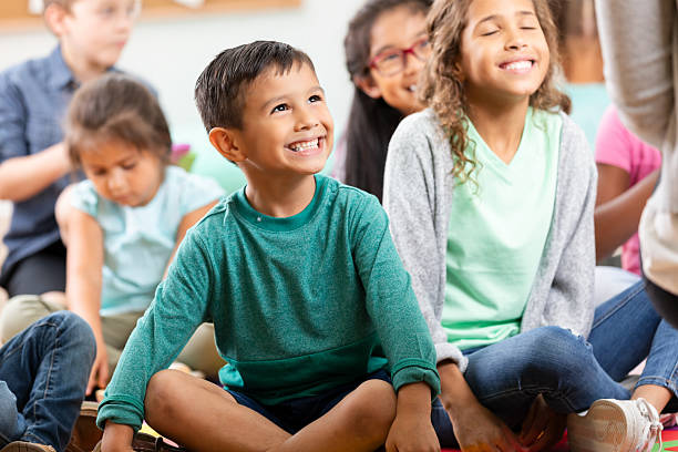 istock Joyful children sit on the floor, engaged and smiling during an indoor activity 2254793005