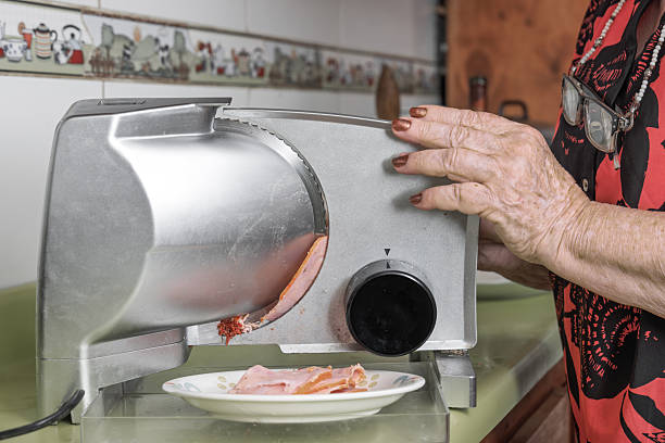 Woman Cutting Ham at Home Using Meat Slicer