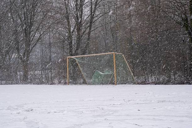 istock Soccer goal on snowy field during winter snowfall 2254796032