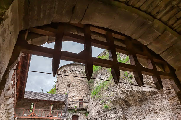 Entrance to the ancient Gate tower with wooden grate that lowers in Rus Gate complex of buildings of the 16th century in Kamianets-Podilskyi, Ukraine, view towards the barbican side