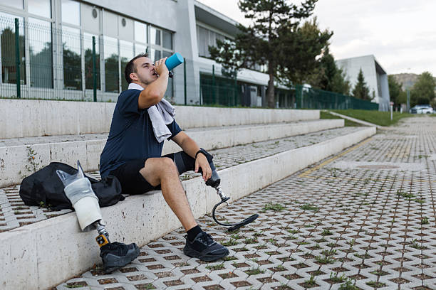 istock Athlete wearing a prosthetic leg with running blade and hydrating after training 2254797247