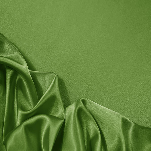 istock Light soft green lime pistachio silk satin. Shiny silky smooth fabric. Wavy folds. Draped. Elegant background. Empty blank space template design ad.Christmas festive birthday.Flat lay, top view table. 2254799856