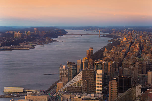 Riverfront Cityscape with Bridge and Manhattan Skyline at Sunset