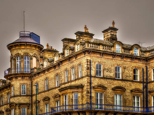 The Zetland Hotel is located on the north east coast of England at Saltburn-by-the-Sea, North Yorkshire. It was designed by William Peachey, architect to the Stockton and Darlington Railway. The seaside resort of Saltburn was developed by Henry Pease who was a director of the Stockton and Darlington Railway. It is a Grade II listed building. The Zetland Hotel, now converted to flats. Source: Wikipedia. Saltburn by the Sea, England. Victoria Hotel building featuring windows, balconies, and traditional architecture