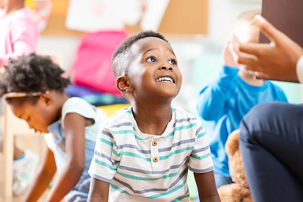 istock Young child attentively listening in a vibrant classroom setting, engaged with learning 2254803346