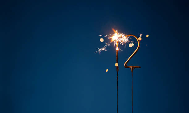 istock 12 years celebration festive background with copy space made with Bengal fires in the form of number Twelve. 2254803563