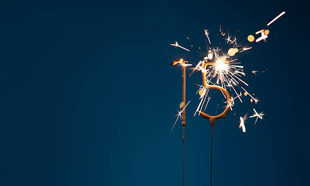 istock 15 years anniversary celebration festive background with copy space made with Bengal fires in the form of number Fifteen. 2254803564