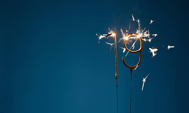 istock 19 years celebration festive background with copy space made with Bengal fires in the form of number Nineteen. 2254803578