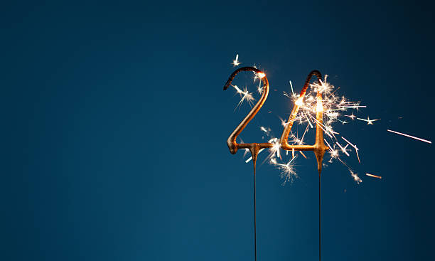 istock 24 years celebration festive background with copy space made with Bengal fires in the form of number Twenty four. 2254803581