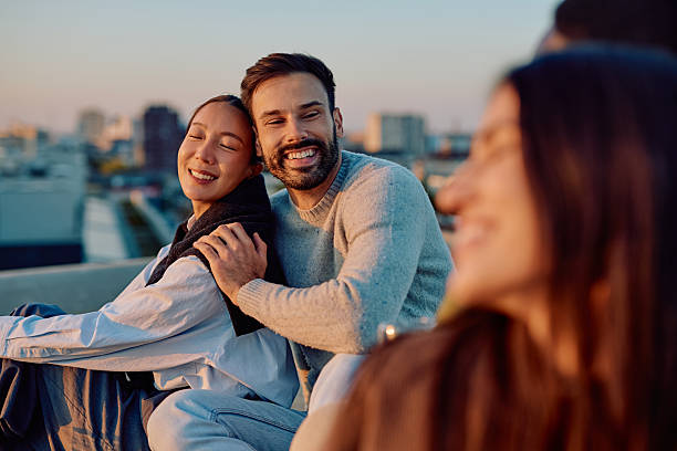 istock Happy diverse couple enjoying city rooftop sunset 2254803949