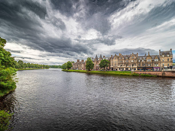 Inverness, Scotland. River Ness flowing past Victorian architecture on Young Street in Inverness, Scotland, under a cloudy sky