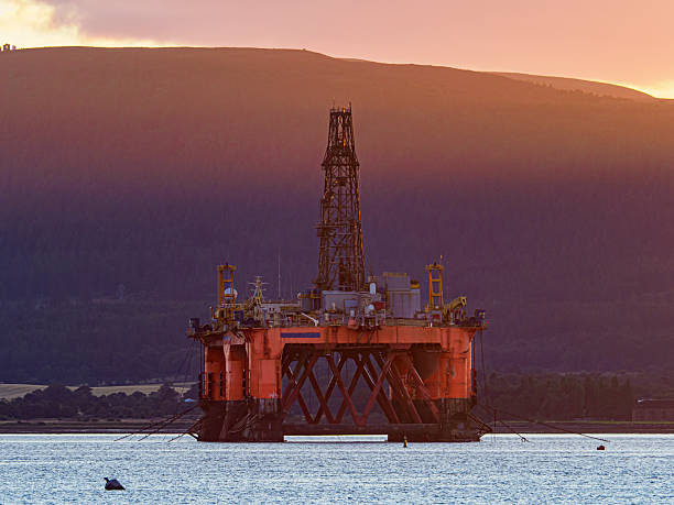 istock Oil rig floating on water during sunset energy industry 2254804435