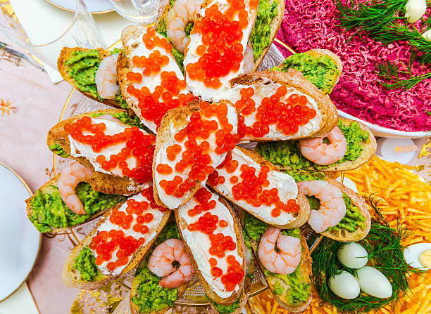 Elegant appetizer platter with bruschetta, shrimp, and caviar for festive occasions