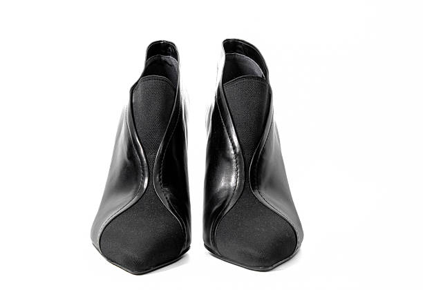 Studio shot of elegant black leather ankle boots with pointed toe and high stiletto heel photographed from multiple angles including side view and rear view isolated on a clean white background ideal for fashion ecommerce luxury footwear advertising and catalog use