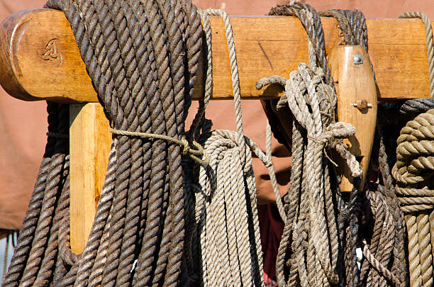 istock Coiled ropes on a carved post and beam of a viking ship replica. 2254808448
