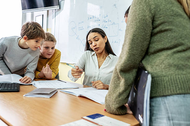 istock A small group of students is in their elementary classroom while a mixed-race teacher guides them through a math and geometry lesson. 2254810219