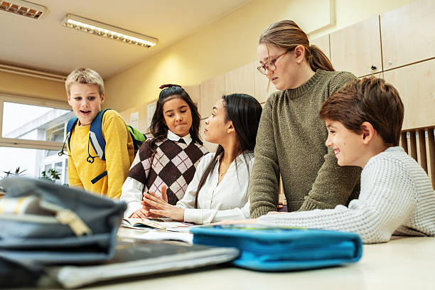 istock A small group of students is in their elementary classroom while a mixed-race teacher guides them through a math and geometry lesson. 2254810230