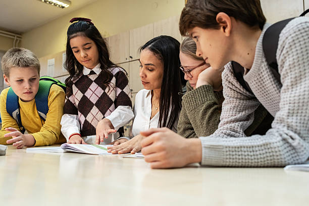 istock A small group of students is in their elementary classroom while a mixed-race teacher guides them through a math and geometry lesson. 2254810233