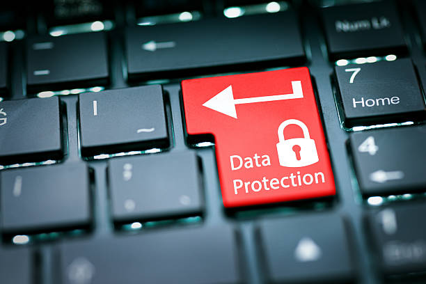 Conceptual close-up image of a computer keyboard featuring a highlighted red key with a lock icon and data protection text, symbolizing cybersecurity, privacy, digital security, and information protection in the digital age.