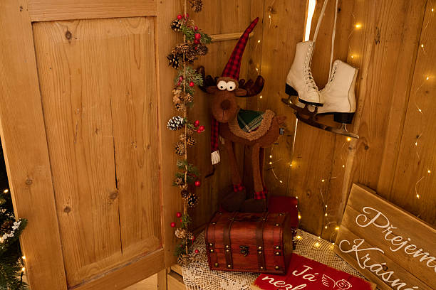 A cozy wooden corner decorated for the holidays, featuring a reindeer figure, ice skates and festive lights