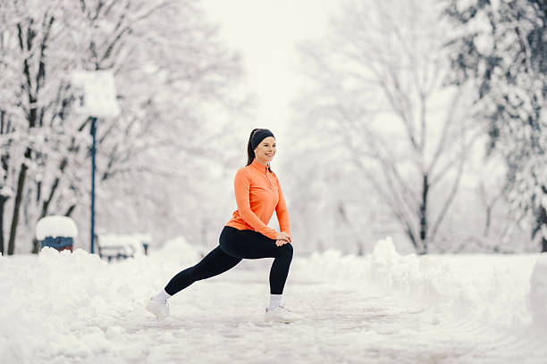 istock Woman doing lunges in snowy park 2254812355