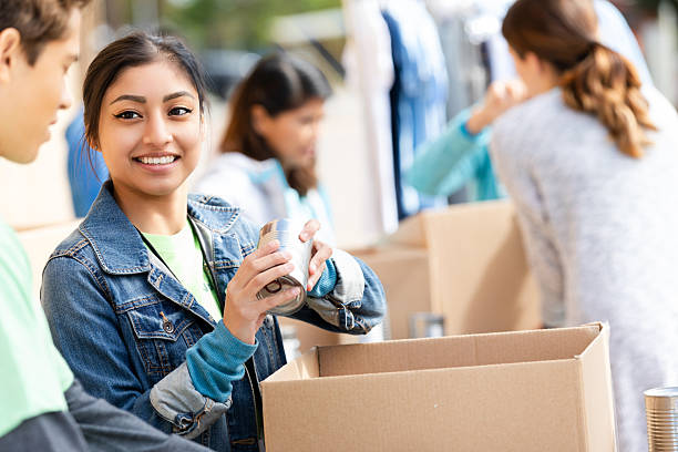 istock Young diverse group volunteering, sorting food donations in a community center for those in need. 2254814130