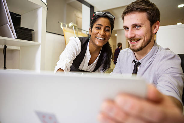 istock Coworking Team Reviewing Project on Laptop in Creative Office 2254815539