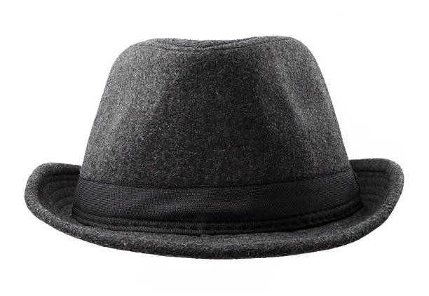 Grey felt hat with black ribbon isolated on a white background. A classic dark gray wool fedora hat with a black ribbon band, shot straight-on in a studio.