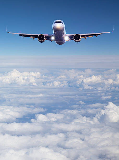 istock Passenger jet airplane flying above clouds vertical view 2254821825