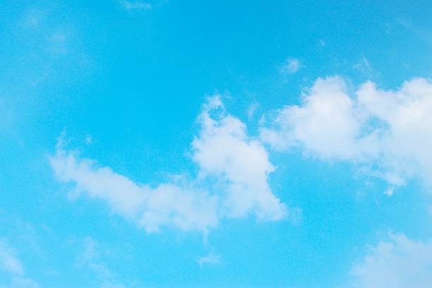 View of bright blue sky with soft white clouds in calm daytime
