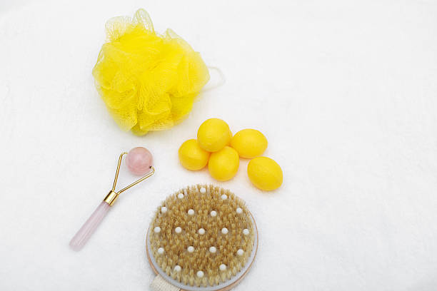 Spa, healthy, hygiene background with beauty tools and natural soap isolated on white grayish fluffy towel background