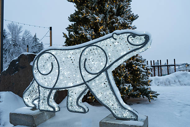 This whimsical polar bear figure, adorned with lights, brings cheer to the snowy landscape. The scene evokes a sense of winter magic and holiday spirit.