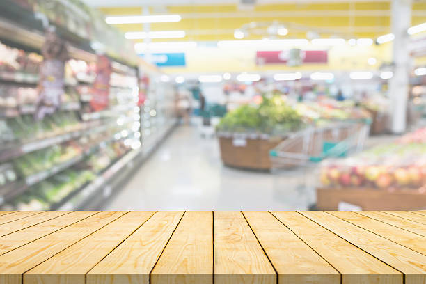 istock Empty wood table top with supermarket blurred background for product display 2254826926