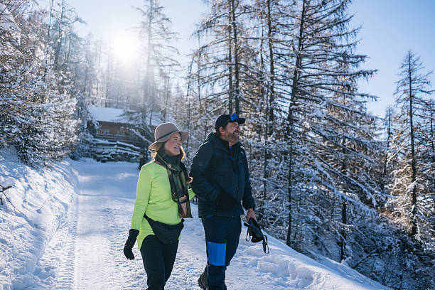 istock Senior couple walk snowy pathway on winter day 2254828835
