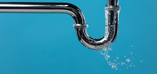 istock Leaking water from chromium stainless steel pipe under sink. Drain leak water from pipe plumbing in bathroom as water clogged drop. Blue bathroom background isolated 2254829878