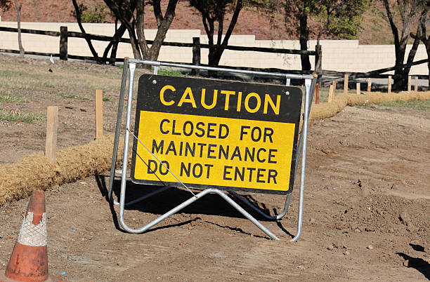 istock Caution - Closed For Maintenance - Do Not Enter sign mounted on a metal frame and placed on bare dirt 2254830706