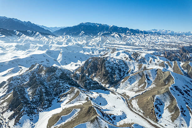 Aerial perspective of rugged snow capped mountains