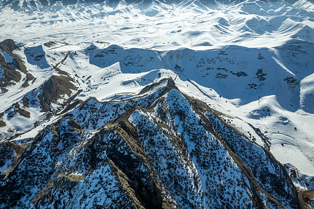 Aerial perspective of rugged snow capped mountains