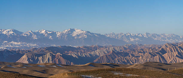 Winter grasslands and distant snow capped mountains