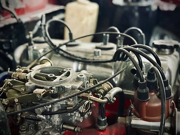 Overhead and close-up view of a car engine in repair workshop