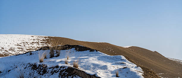 Grassland slopes covered with snow in winter