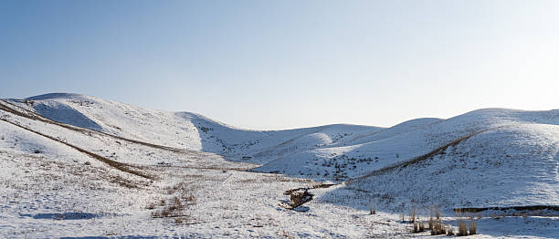 Grassland slopes covered with snow in winter