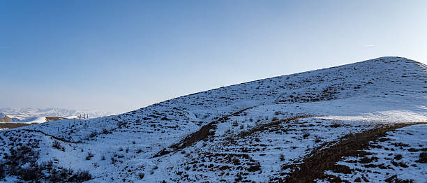 Grassland slopes covered with snow in winter