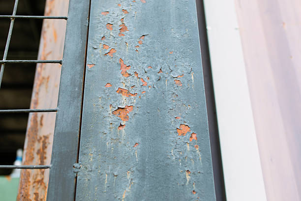 Weathered old paint cracked and peeling off of a wooden door