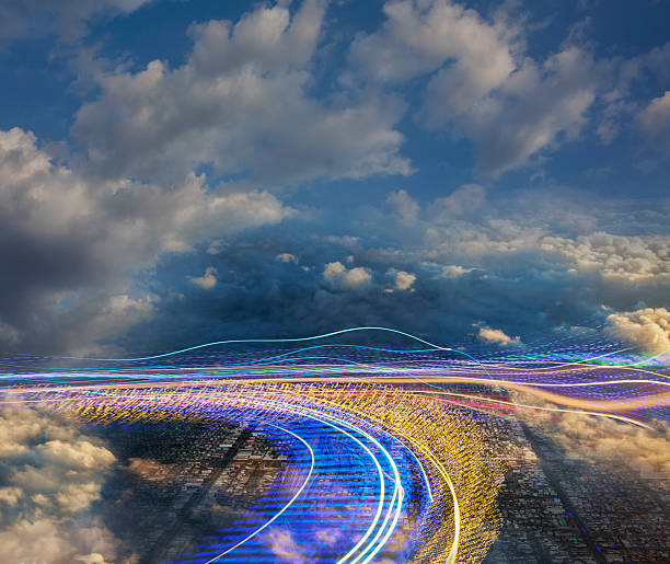 istock Conceptual image of rows of curving data light streams and cloudy sky 2254839890